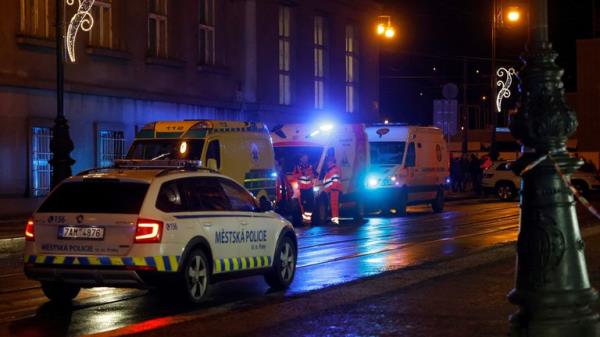 A police car drives past ambulances parked near the area of the shooting at one of the buildings of Charles University in Prague, Czech Republic, December 21, 2023. REUTERS/David W Cerny<em></em>
