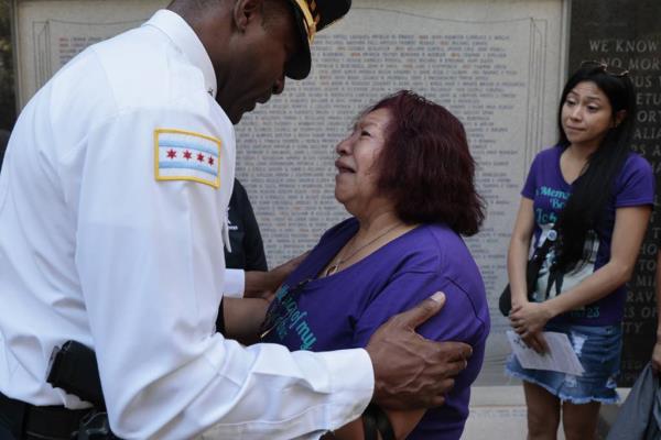 Larry Snelling, Mayor Brandon Johnson's nominee for police superintendent, comforts Carmen Cruz, who lost her son Officer John Cruz to suicide, as she and family members attend the Chicago Fraternal Order of Police's ceremony on Sept. 1, 2023, to ho<em></em>nor officers who have recently died of suicide.